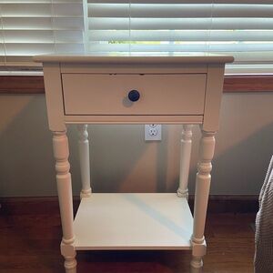 White nightstand. Has some small minor dings on drawer.